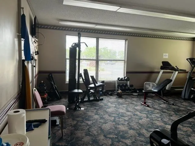 a living room with furniture a flat screen tv and a window