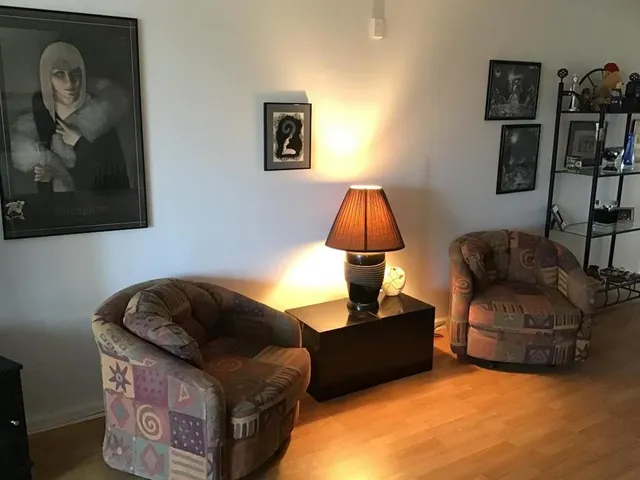 a living room with furniture and a lamp