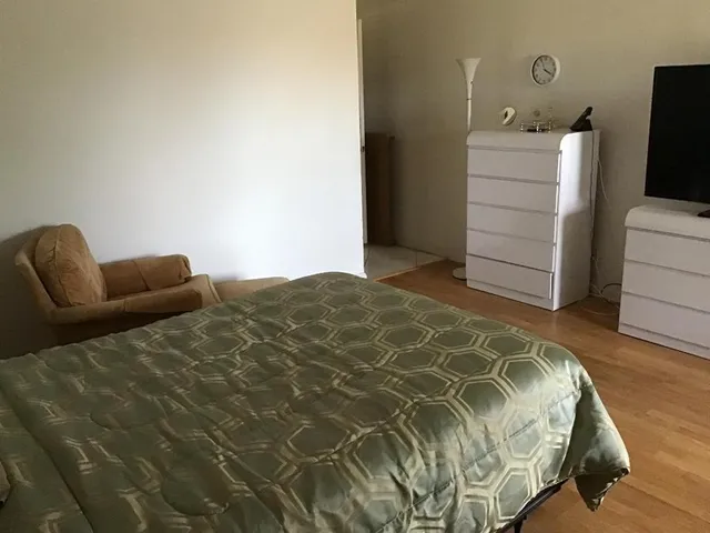 a bedroom with a bed and a television