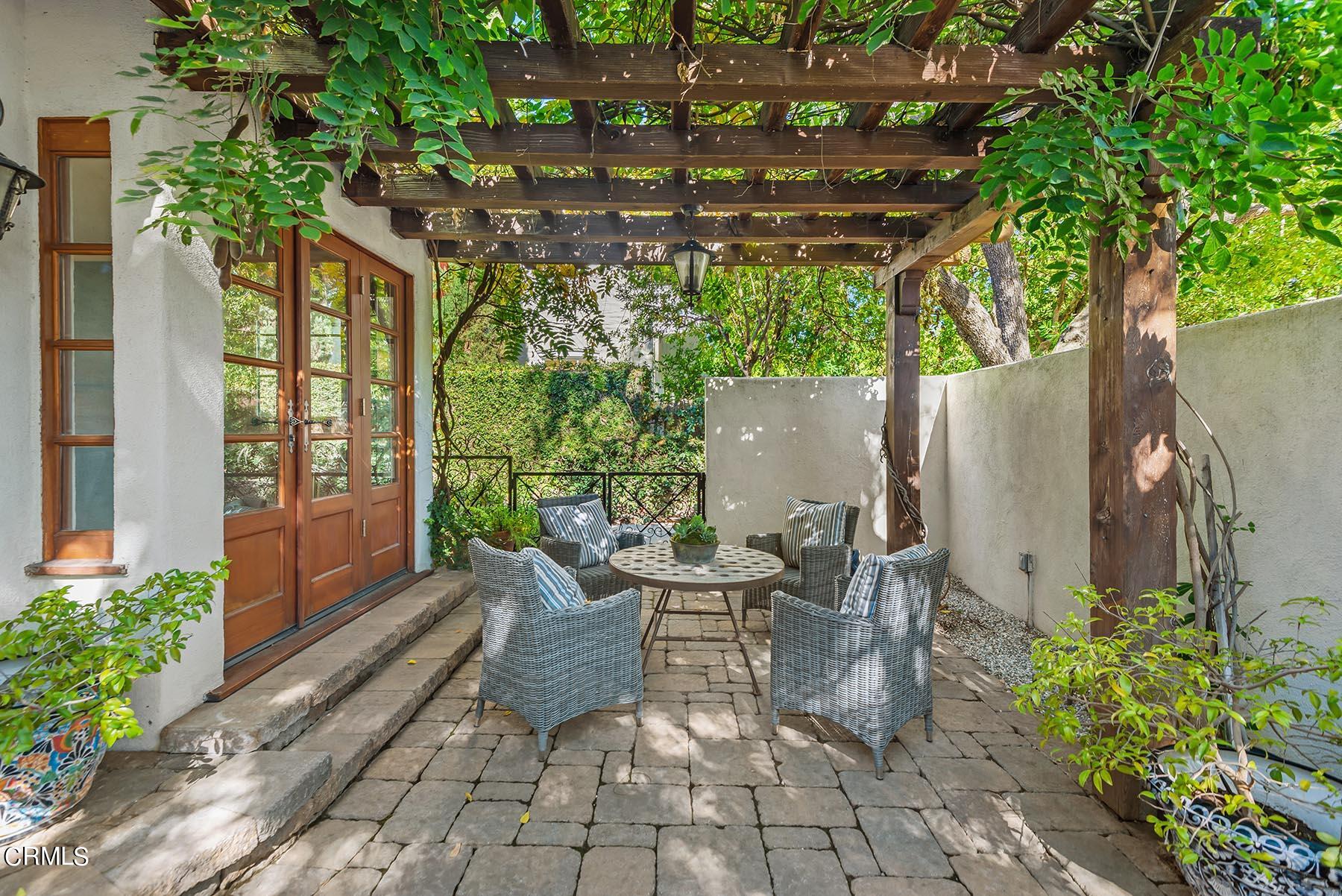 695 Holladay Road Pasadena, CA 91106 - Photo 14 of 44 a view of a patio with table and chairs potted plants with large tree