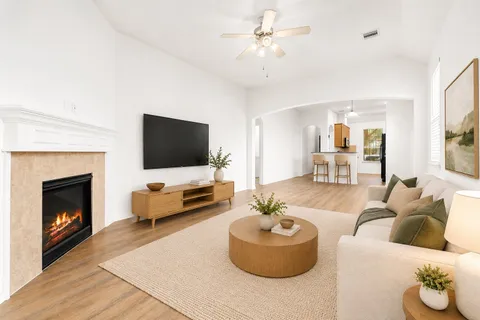 a living room with furniture and a fireplace