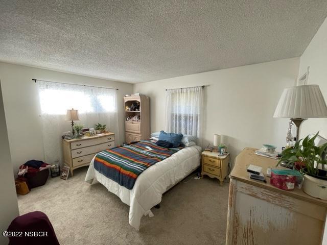 4084 Stardust Road Lompoc, CA 93436 - Photo 10 of 27 a bedroom with a bed and a potted plant