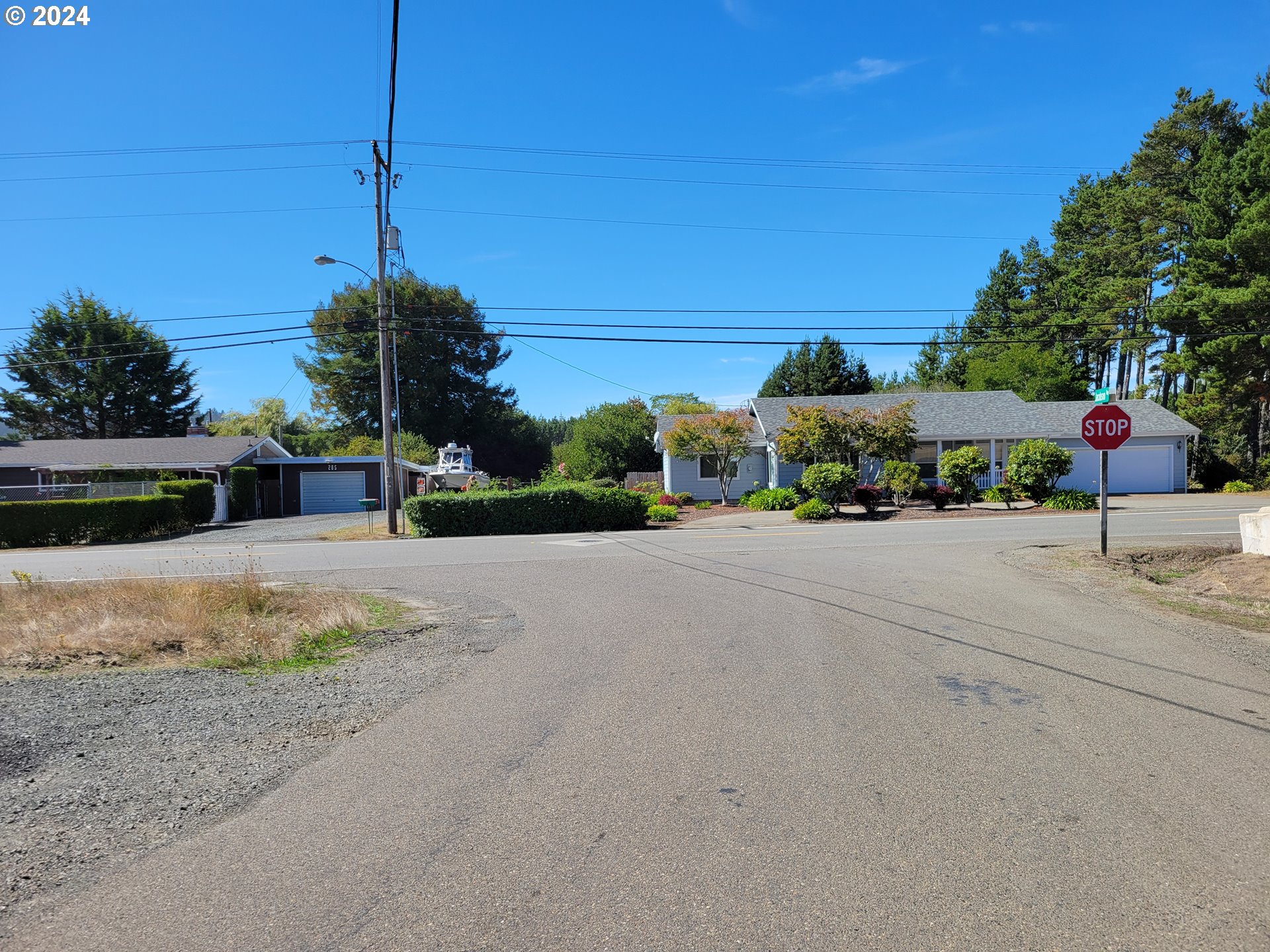 821 Jacobson Way Lakeside, OR 97449 - Photo 3 of 5 a view of a street with a cars parked on the road