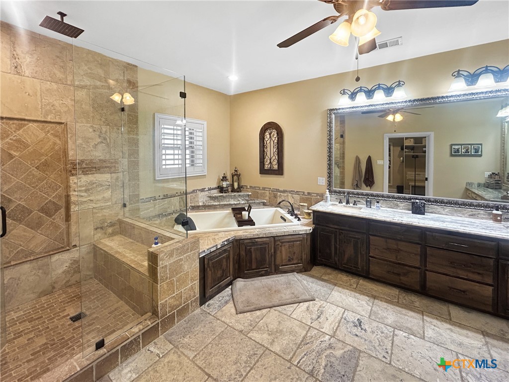 1747 Cr 139 Loop Cameron, TX 76520 - Photo 12 of 35 a spacious bathroom with a tub sink shower and mirror