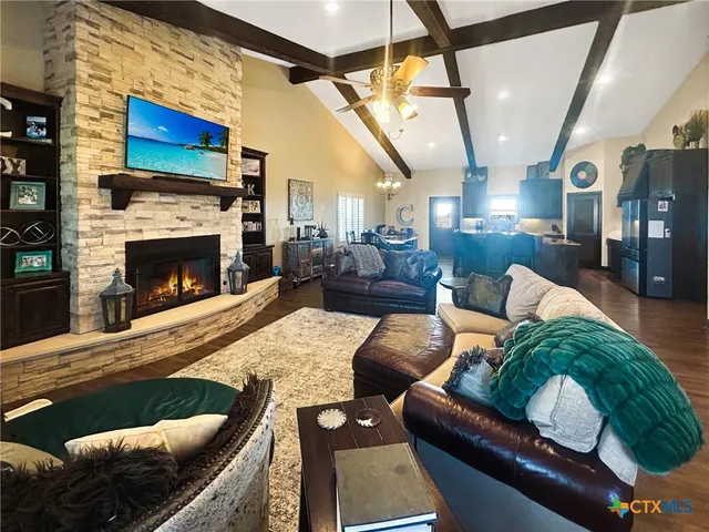 a living room with fireplace furniture and a wooden floor