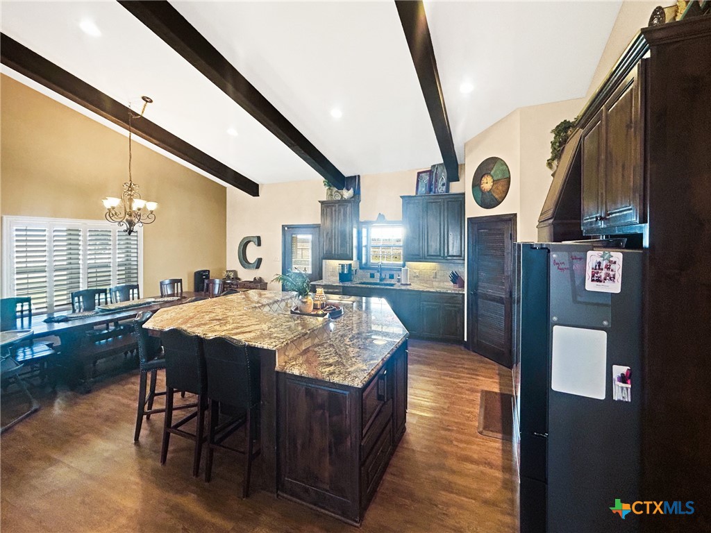 1747 Cr 139 Loop Cameron, TX 76520 - Photo 9 of 42 a large kitchen with stainless steel appliances granite countertop a sink and wooden floor