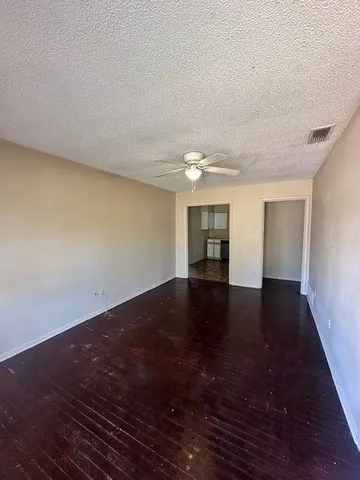 a view of a room with an empty space and a window