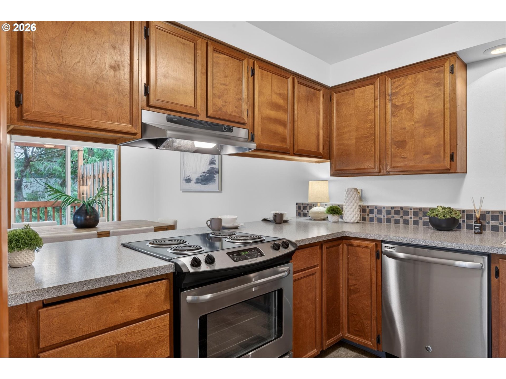 18145 Southwest Monte Verdi Boulevard Beaverton, OR 97007 - Photo 11 of 24 a kitchen with a sink a stove cabinets and a window