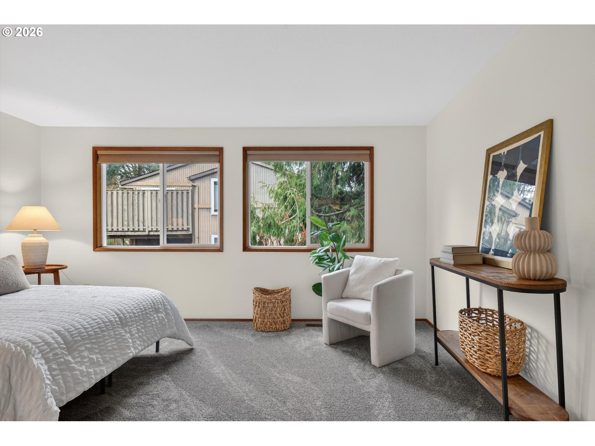 18145 Southwest Monte Verdi Boulevard Beaverton, OR 97007 - Photo 12 of 24 a bedroom with a bed a mirror and a large window