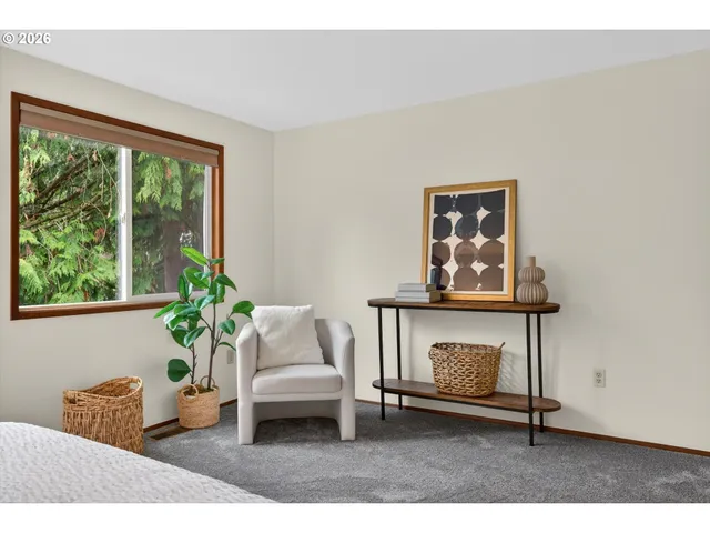 a living room with furniture a window and a potted plant