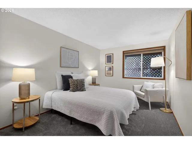 a bedroom with a bed a window and wall painting