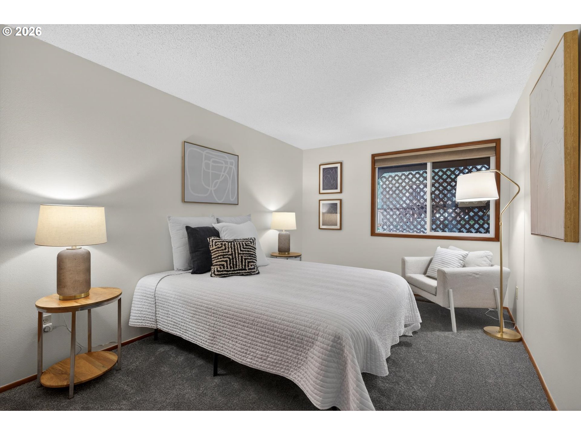 18145 Southwest Monte Verdi Boulevard Beaverton, OR 97007 - Photo 19 of 24 a bedroom with a bed a window and wall painting