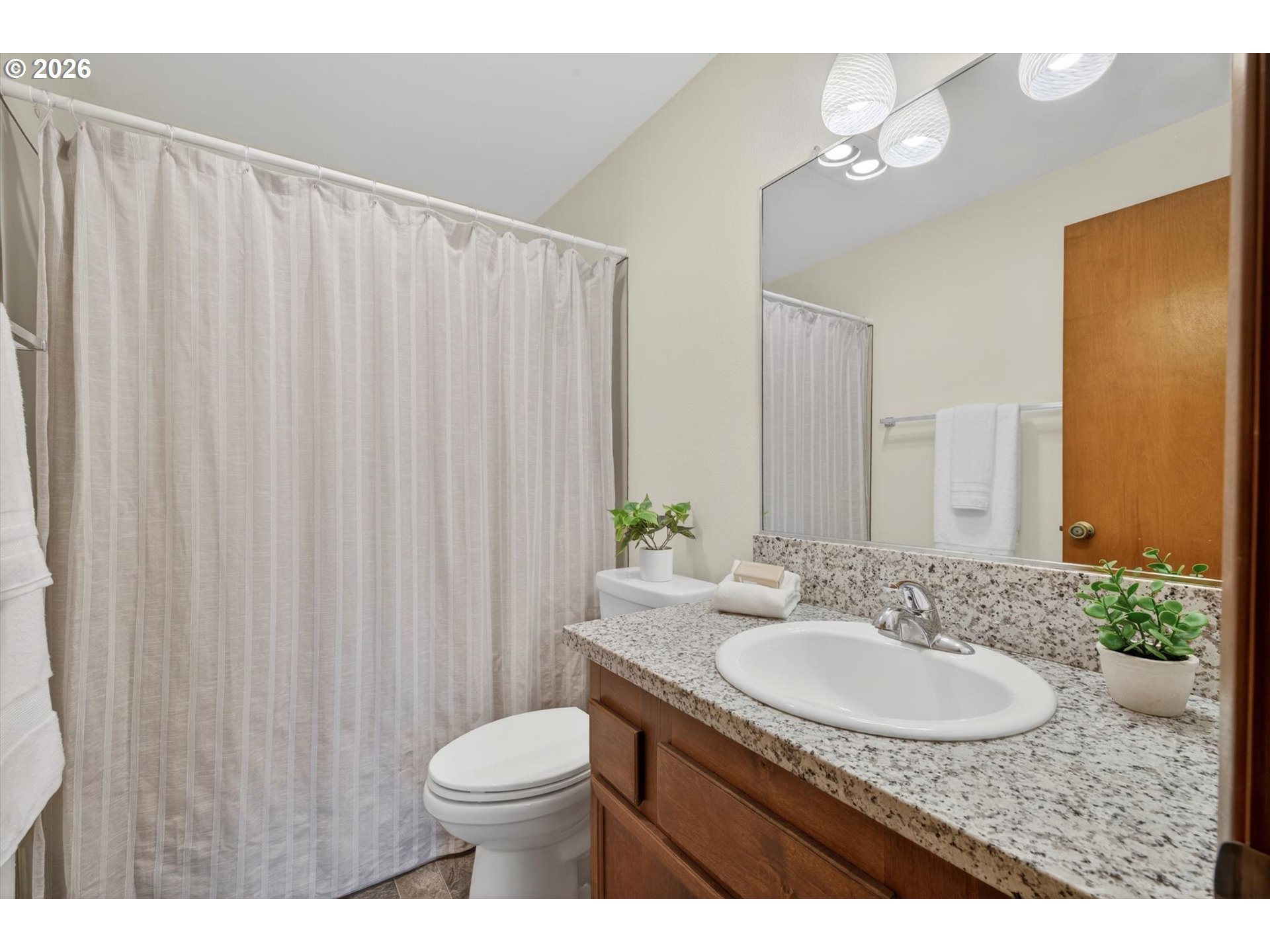 18145 Southwest Monte Verdi Boulevard Beaverton, OR 97007 - Photo 20 of 24 a bathroom with a granite countertop sink toilet and a mirror