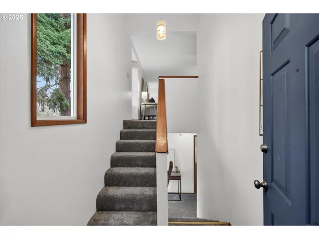 a view of entryway and hall with wooden floor