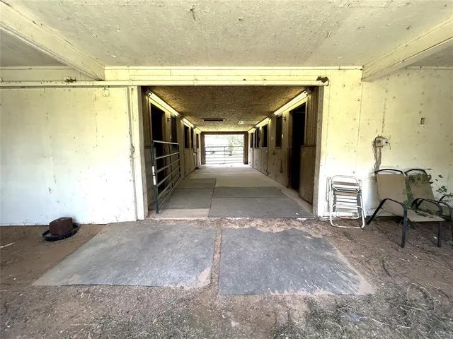 a view of a hallway with furniture and a window