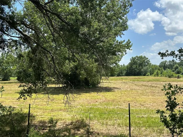 a front view of house with yard and swimming pool