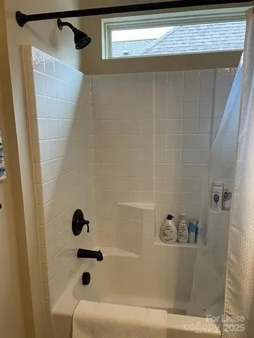 a view of room with mirror and furniture