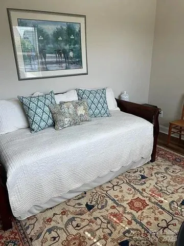 a room with painting on the wall and a window