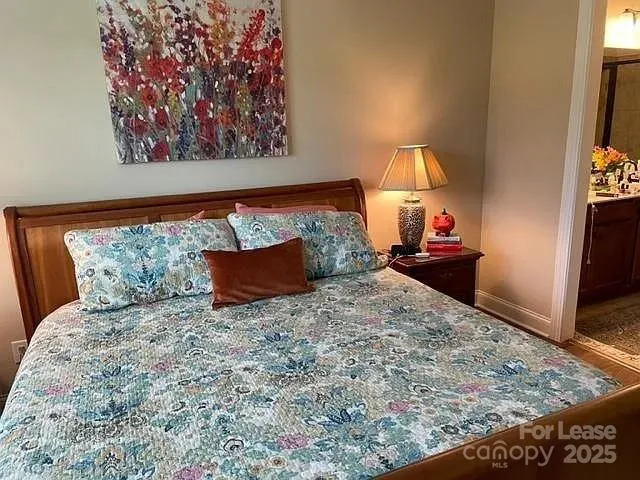 a bed sitting in a bedroom with a balcony