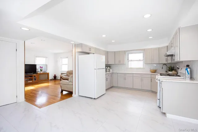 a kitchen with refrigerator and cabinets