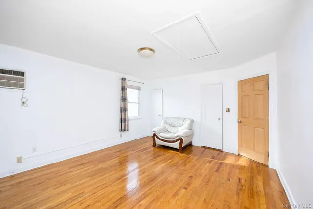 a view of a room with wooden floor and bench