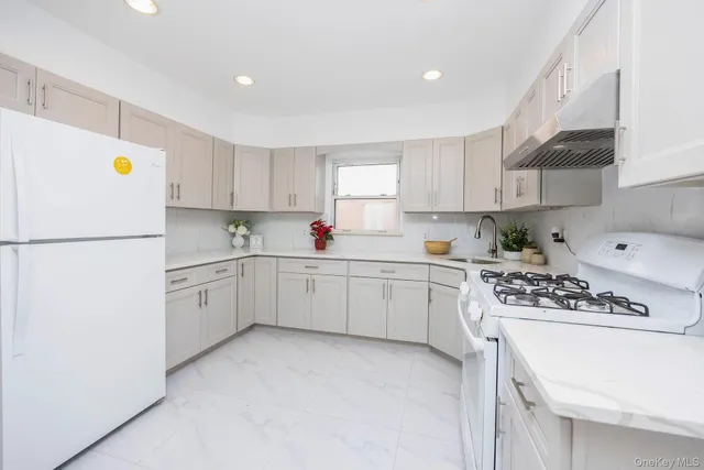 a kitchen with a white cabinets and white appliances