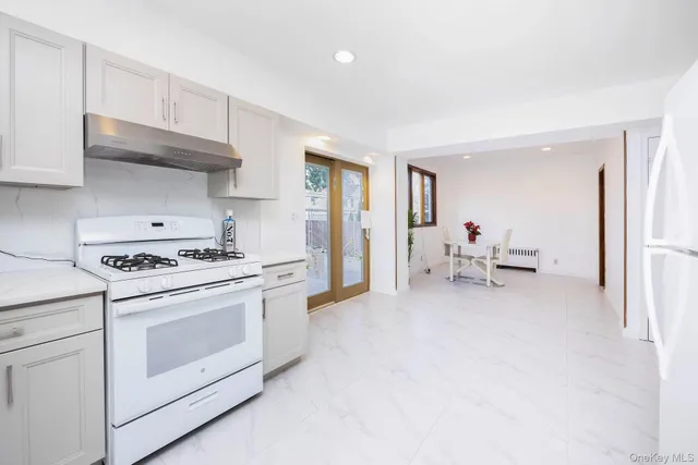 a kitchen with furniture and a stove top oven