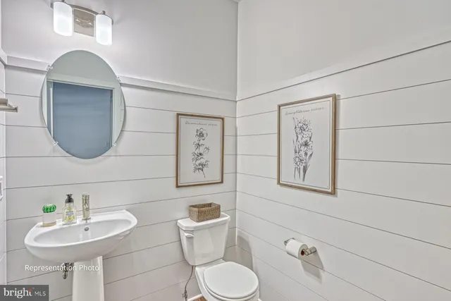 a bathroom with a toilet sink and mirror