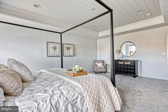 a bedroom with a bed a mirror and a table