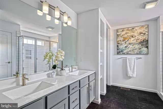 a bathroom with a double vanity sink and a mirror