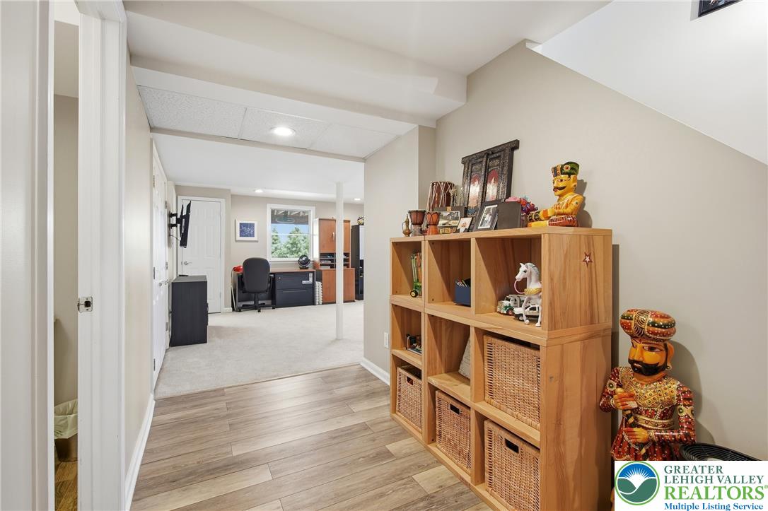 115 West Butternut Road Hellertown, PA 18055 - Photo 53 of 97 A well-appointed lower-level space features engineered wood and carpet flooring.
