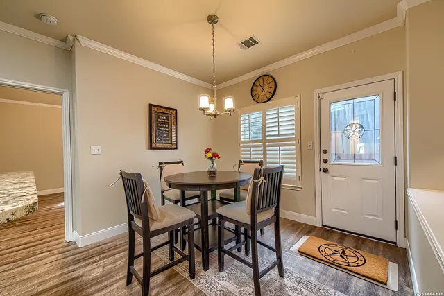 a view of a dining room with furniture and window