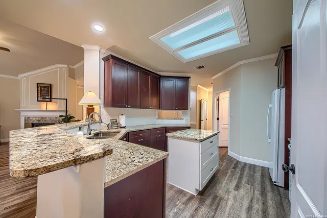a kitchen with a stove a sink and a refrigerator