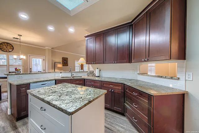 a kitchen with a stove sink and cabinets