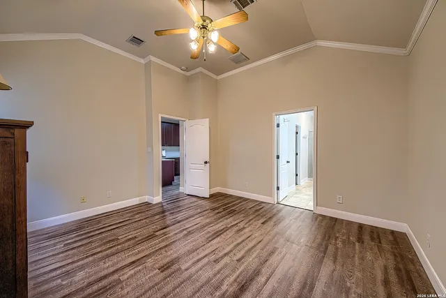 a view of an empty room with wooden floor
