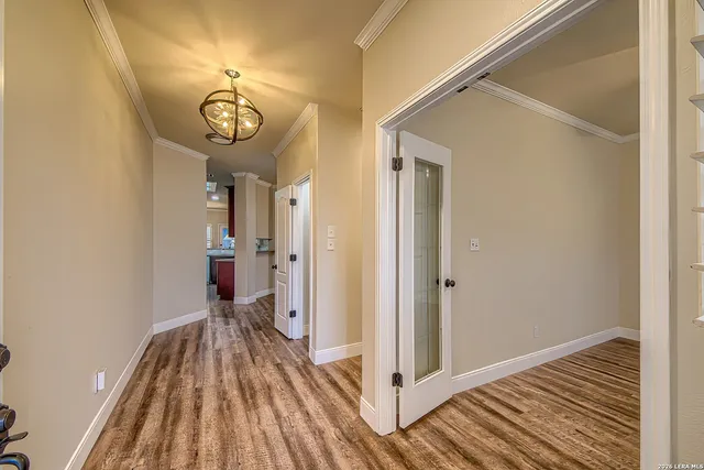 a view of a hallway with wooden floor