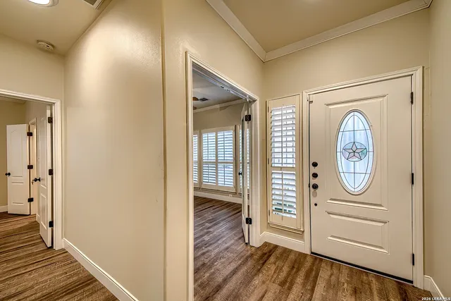 a view of a hallway with wooden floor