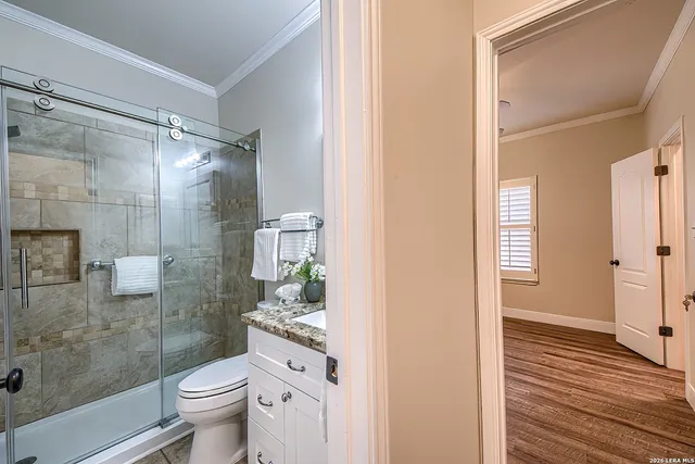 a bathroom with a shower toilet and sink