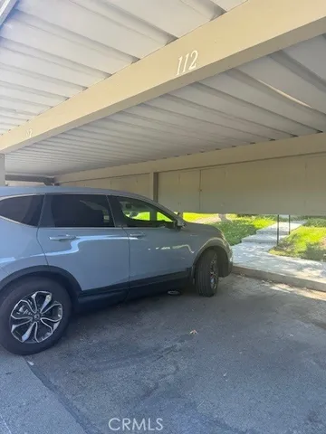 a view of a house with pool lawn chairs and a yard