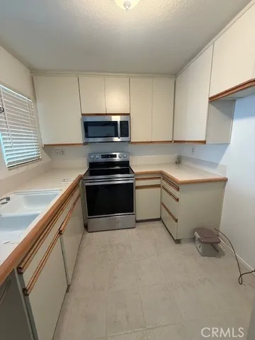 a kitchen with a sink stove and cabinets