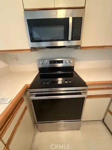 a stove top oven sitting inside of a kitchen