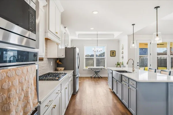 a kitchen with sink refrigerator and stove