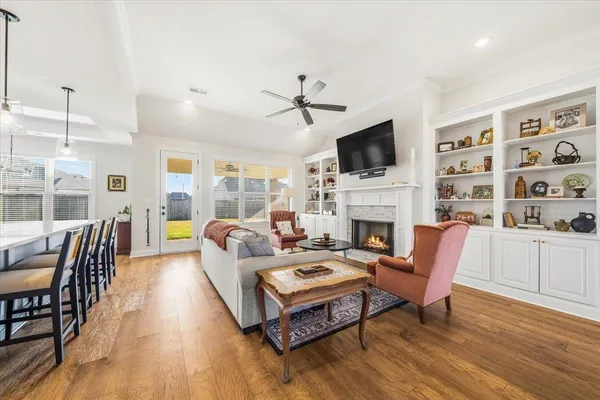 a living room with fireplace furniture and a flat screen tv