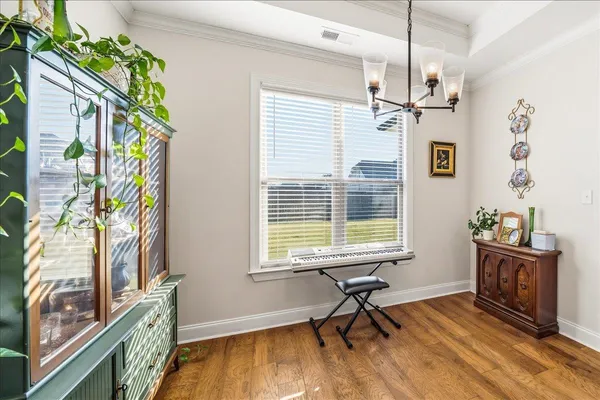 a workspace room with furniture and a window