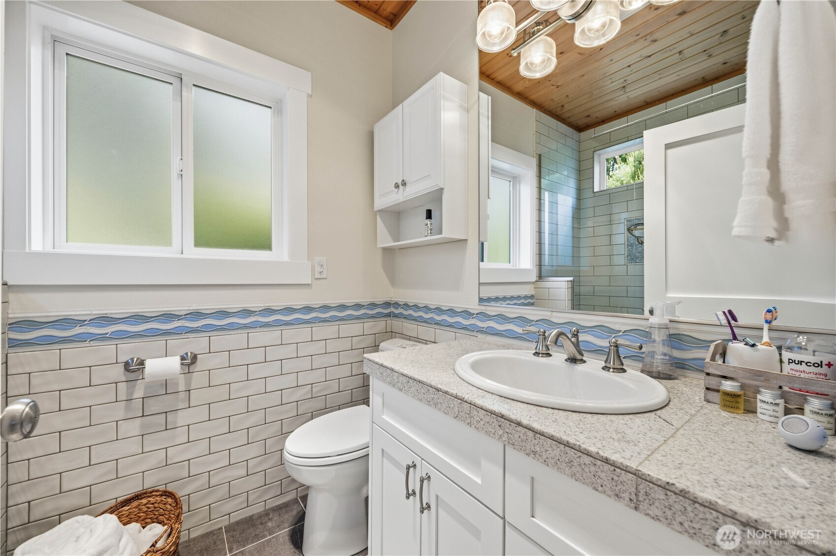 141 Sunset Place Manson, WA 98831 - Photo 17 of 38 a bathroom with a sink a toilet and mirror