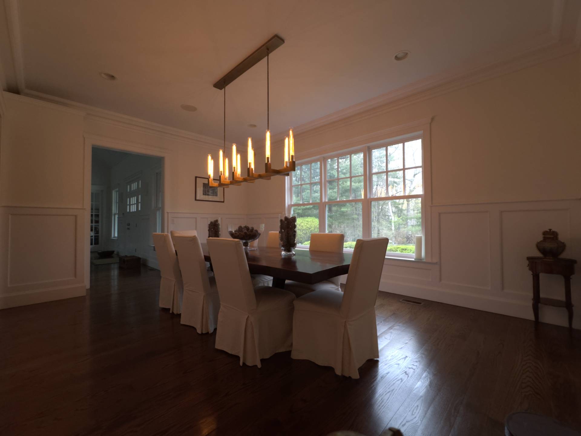 206 Bull Path East Hampton, NY 11937 - Photo 11 of 22 a view of a dining room with furniture a chandelier and wooden floor