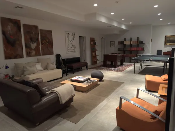 a living room with furniture kitchen view and a large window