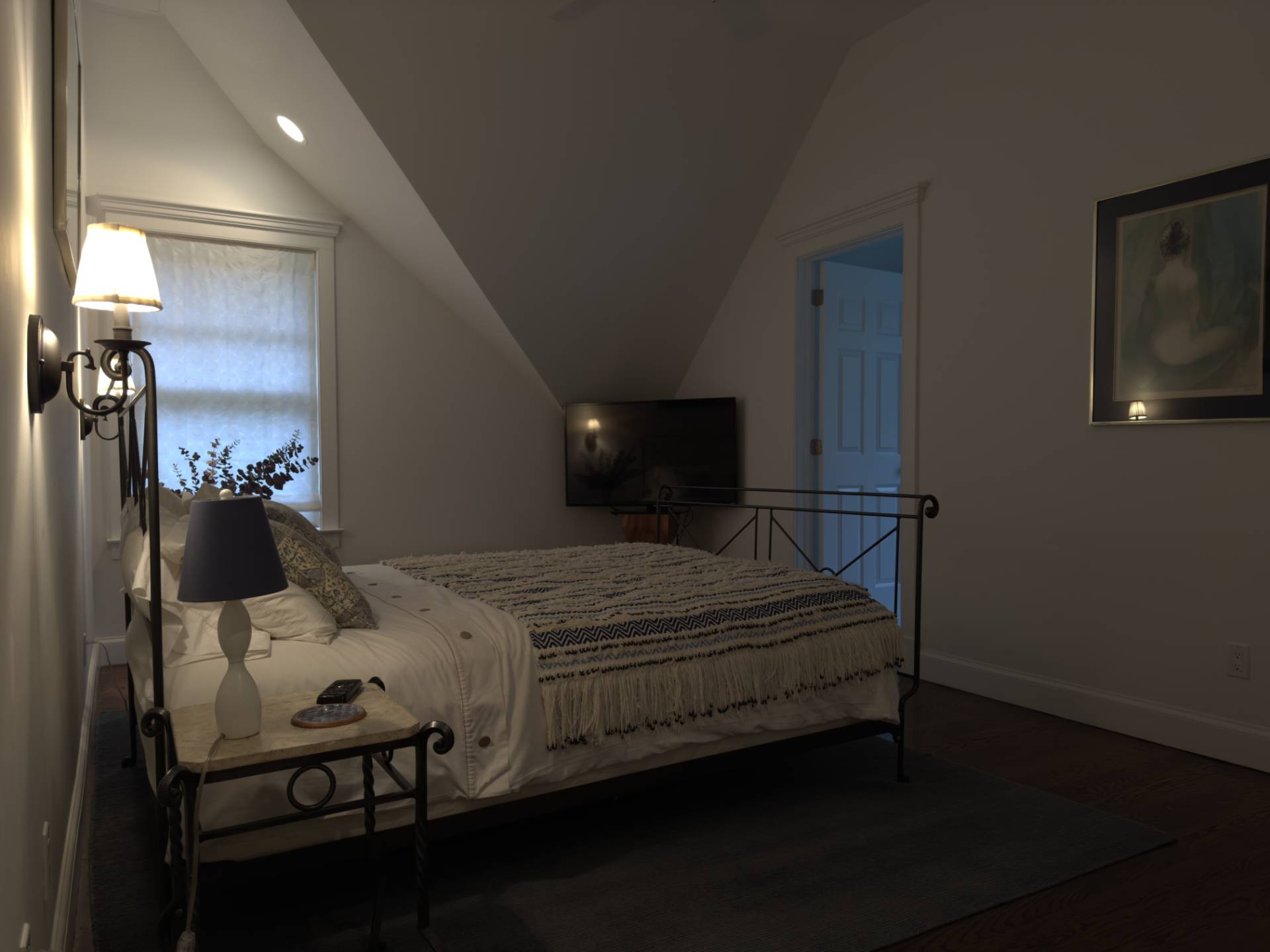 206 Bull Path East Hampton, NY 11937 - Photo 13 of 22 a bedroom with a bed a mirror and lamp