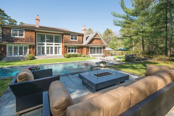 a view of a house with swimming pool and sitting area