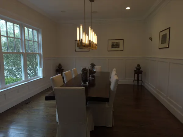 a living room with furniture a chandelier and a window